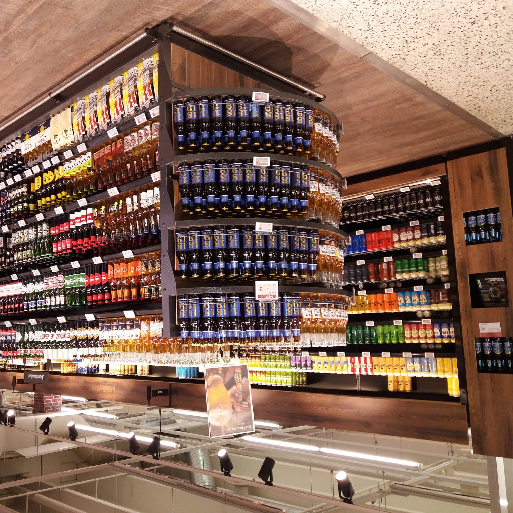 Shelves of bottled beer in a brightly lit shop.