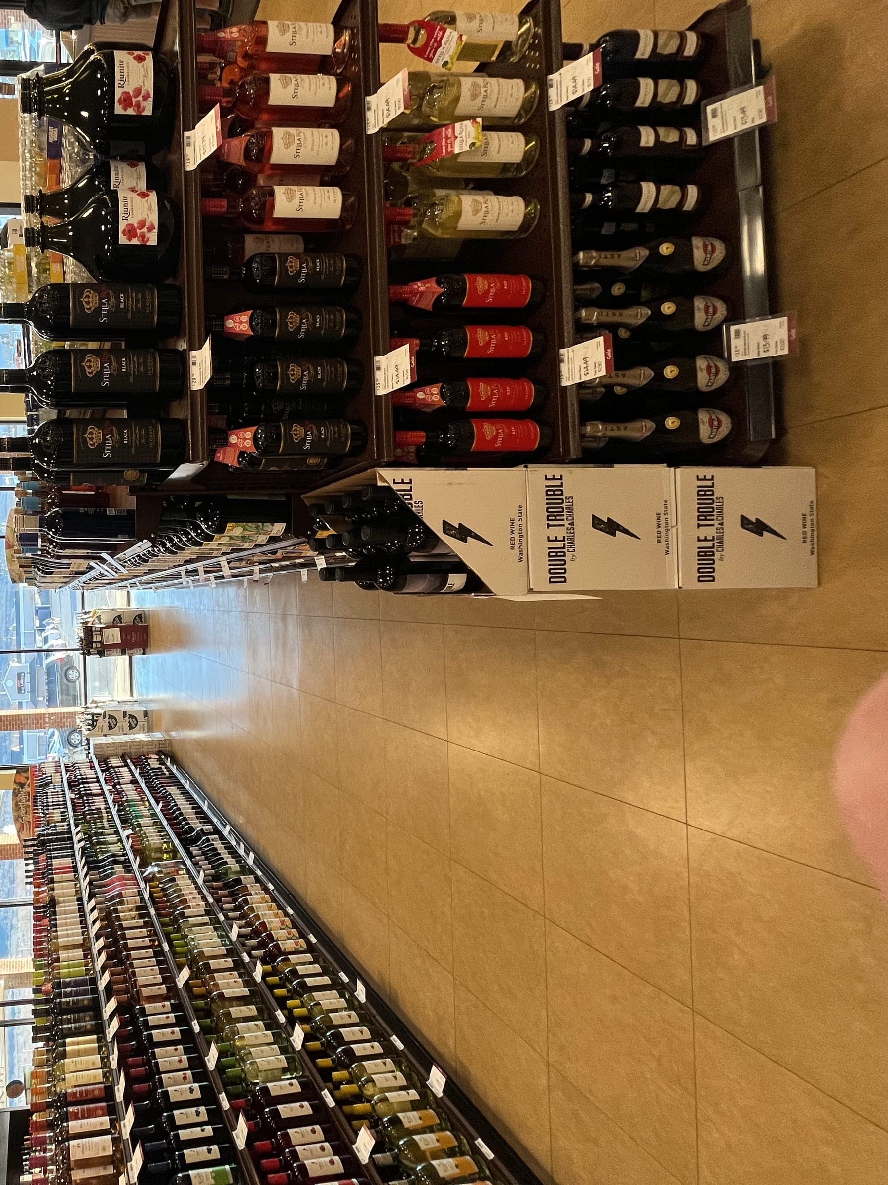 Bottles of spirits lined up along a shop shelf.